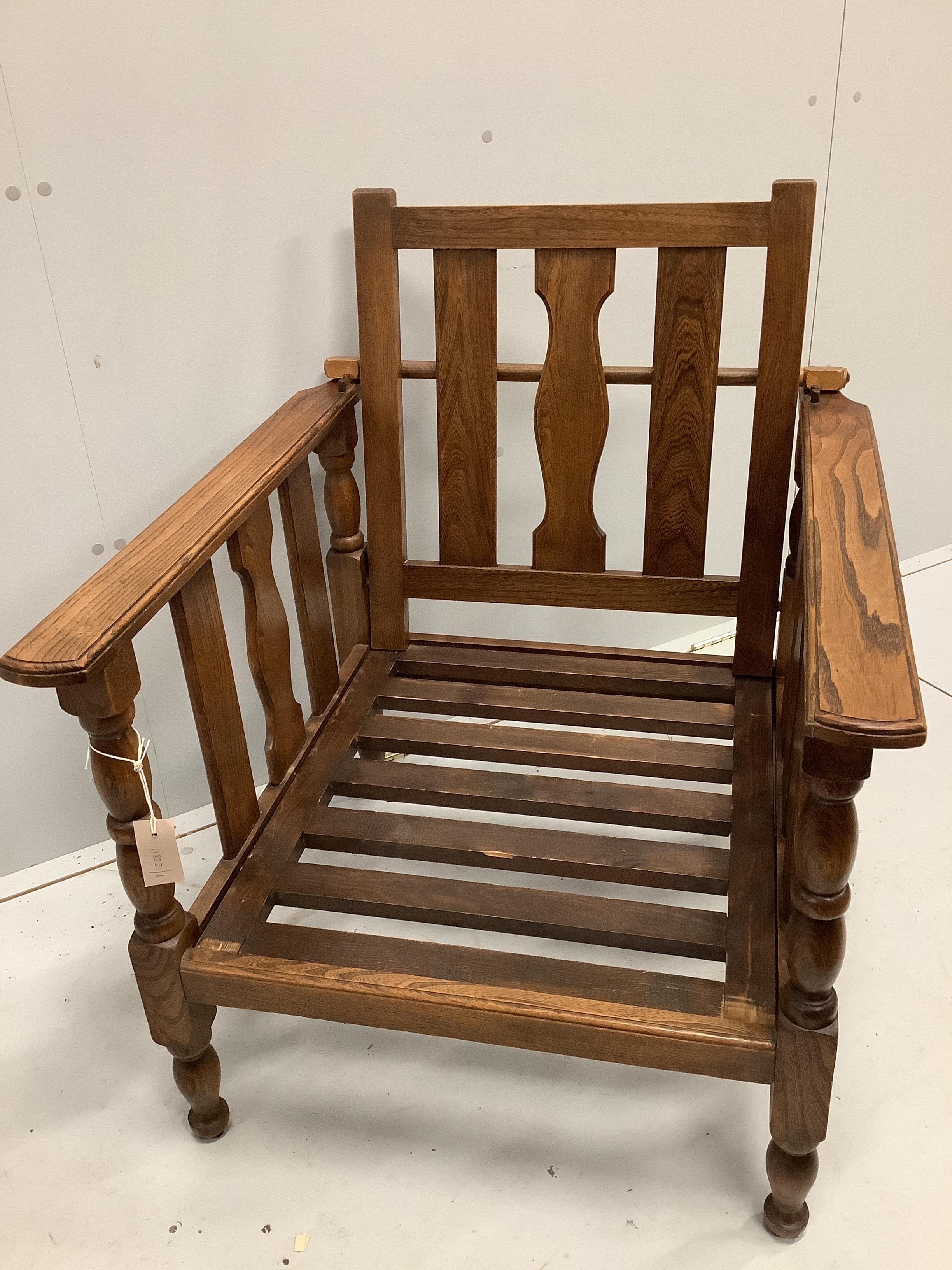 An early 20th century oak reclining elbow chair with Kilim seat and back, width 71cm, depth 78cm, height 84cm